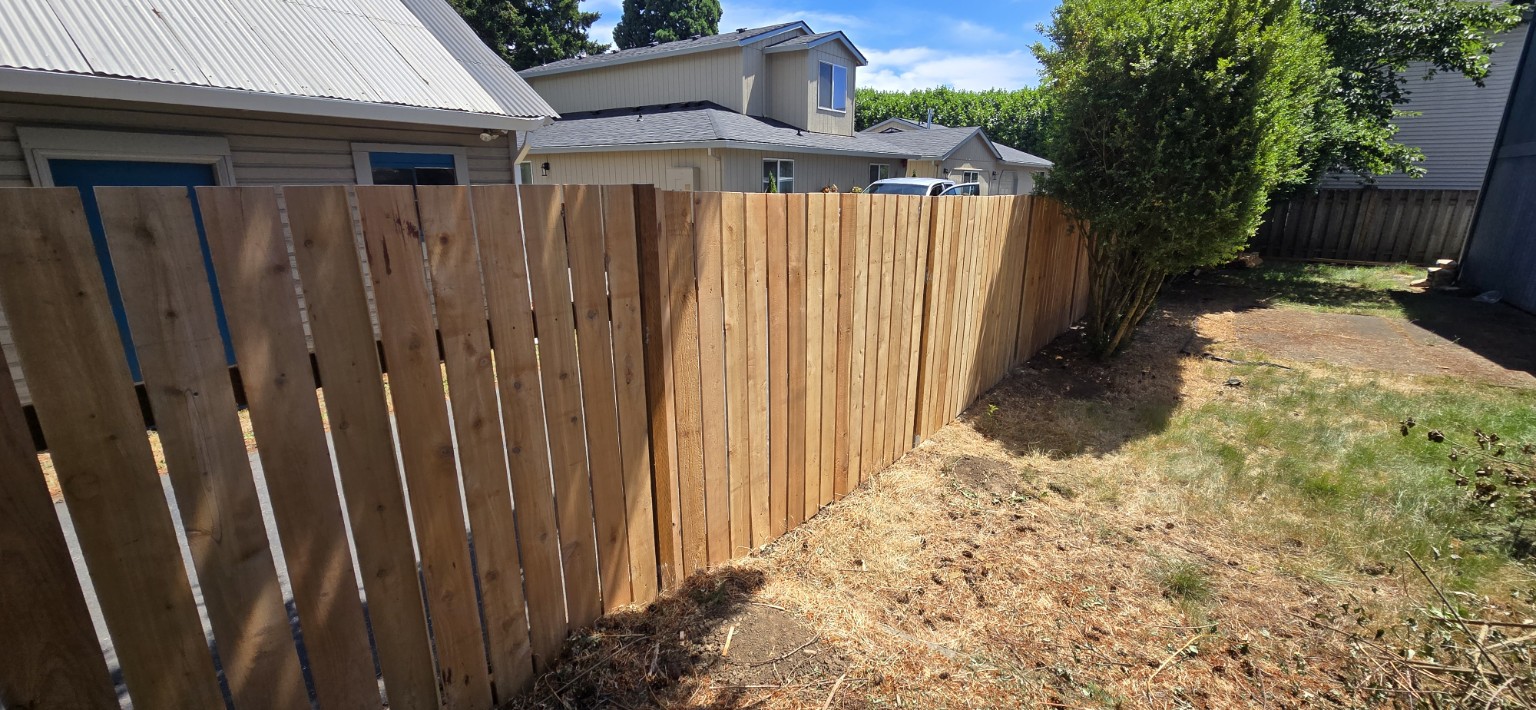 Wood privacy fence along a residential backyard